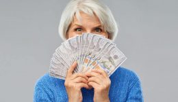 senior woman with hundred dollar money banknotes